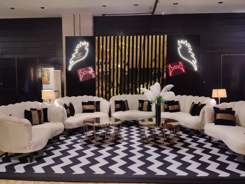 Black and white checkered floor with white furniture, creating a stylish setting for birthday planners in Delhi.